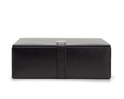 Heritage Large Valet Case in smooth black plant-based materials, shown closed from a straight front view displaying its substantial rectangular silhouette and central vertical closure strap with a silver metal tab.