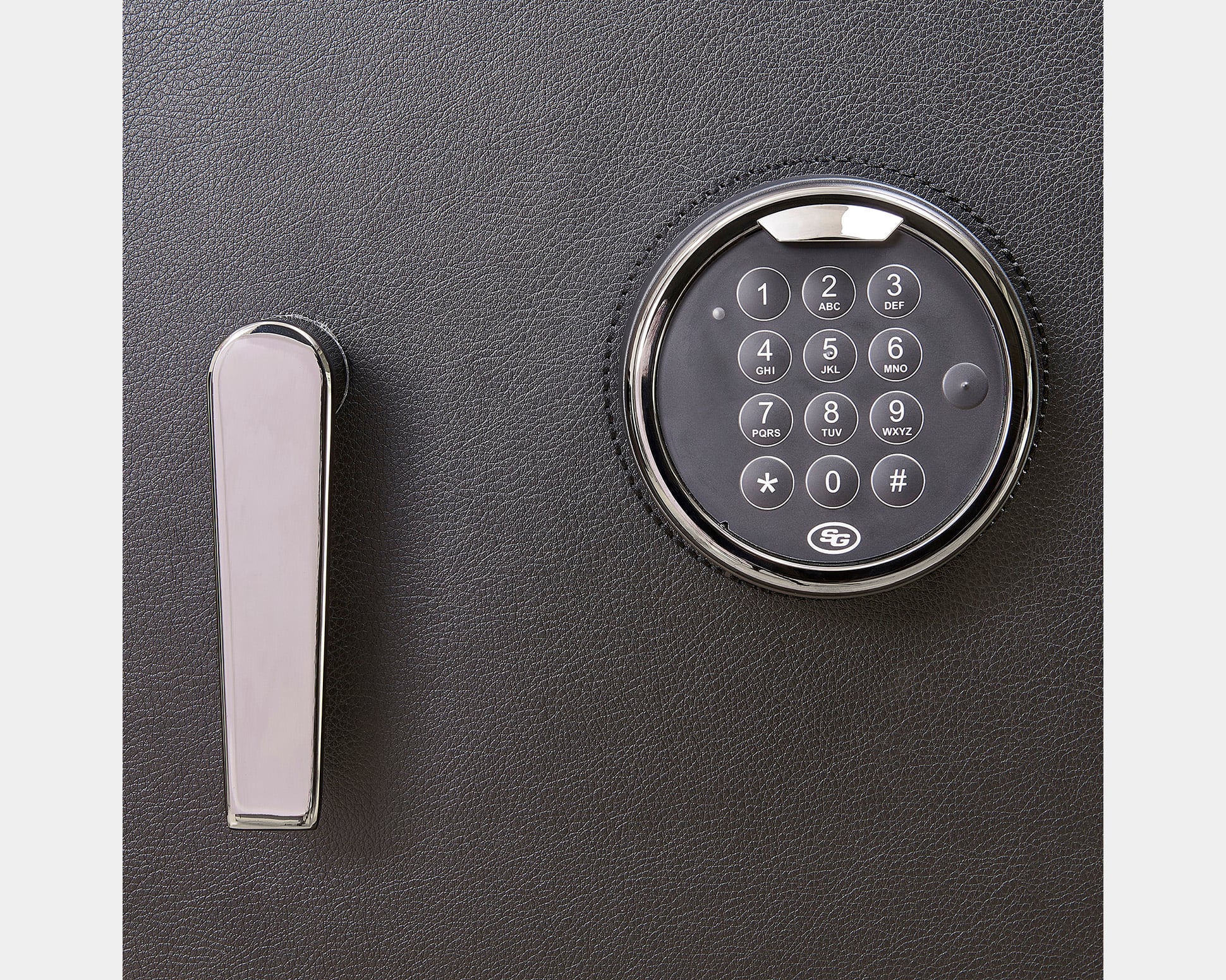 WOLF Athos Safe electronic keypad lock detail. Close-up of the WOLF Athos Safe keypad and handle on the textured safe door.