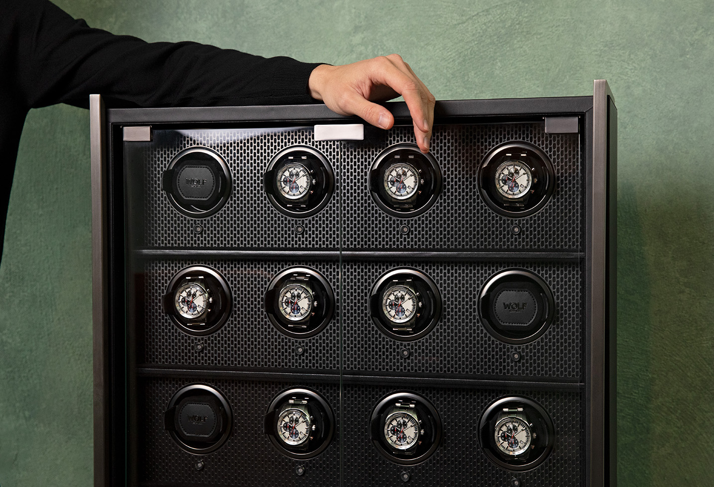 WOLF Axis watch winder cabinet with multiple automatic winding modules. WOLF Axis 12 Piece Watch Winder Cabinet, showing multiple winding modules and a perforated steel interior.
